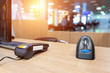 Emty cashier desk counter POS terminal with barcode scanner, receipt printer, wallet and credit card reader equipment. Payment trade through mobile and wireless NFC technology. Workplace and career