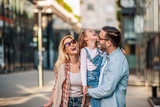 Fototapeta  -  Happy young family of three smiling while spending time together