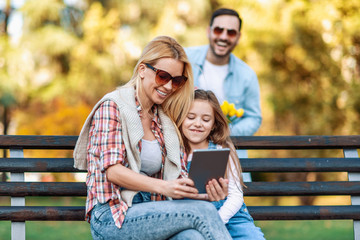 Wall Mural - Happy family of three having fun together outdoor