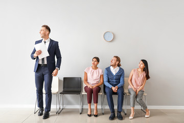 Canvas Print - Young people waiting for job interview indoors