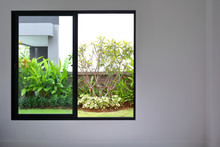 Slide Glass Window On White Wall Interior In Modern Empty Room With Small Garden Landscaping Outside A New House