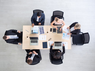 Top view of caucasian  businesspeople  meeting on the wood table. Business teamwork having meeting in modern office.