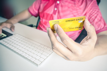 Poster - Man paying with credit cards on computer at home.