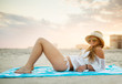 © Michael Marquand - young woman relaxing on the beach
