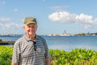 A senior man, a veteran, visits the Pearl Harbor Memorial during a family trip to Honolulu, Hawaii.
