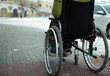 © andreysha74 - A disabled person in a wheelchair moves around the city in winter.