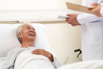 Wall Mural - senior asian man talking to doctors