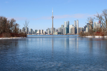 Wall Mural - City skyline with frozen lake in winter