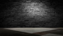 Background Of An Empty Black Room, A Cellar, Lit By A Searchlight. Brick Black Wall And Wooden Floor