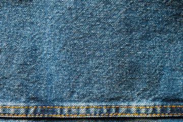 Poster - Selective focus blue jean denim top view close up shot to the detail of fabric. textile material and cotton patter tough and durable garment style. For background or wallpaper with copy space for text