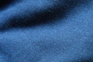 Wall Mural - Selective focus blue jean denim top view close up shot to the detail of fabric. textile material and cotton patter tough and durable garment style. For background or wallpaper with copy space for text