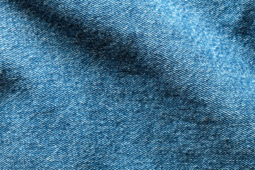 Poster - Selective focus blue jean denim top view close up shot to the detail of fabric. textile material and cotton patter tough and durable garment style. For background or wallpaper with copy space for text