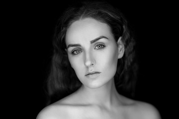 Beauty portrait of a young beautiful brunette girl with long black straight flying hair. Black and white