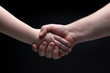 © Denis - Handshake, father holds hand son. Father and Son Relationship Concept. Dark background