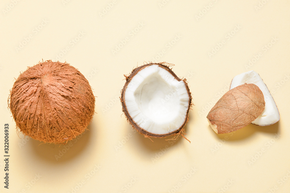 Ripe coconuts on color background