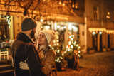 Fototapeta  - Outdoor night portrait of young happy hugging couple, model looking at each other, posing in street of European city. Copy, empty space for text