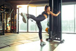© master1305 - Calm. Young muscular caucasian woman practicing in gym with the weights. Athletic female model doing strength exercises, training her lower body, legs. Wellness, healthy lifestyle, bodybuilding.