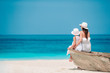 © travnikovstudio - Beautiful mother and daughter at the beach enjoying summer vacation.