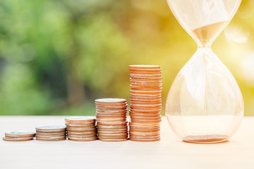 money times memory concept, coins stack with sand hourglass