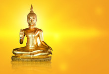 Golden Buddha Statue With Glittering Aura On A Golden Yellow Background For Design And A Beautiful Background.