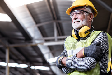 Industrial Engineers in Hard Hats.Work at the Heavy Industry Manufacturing Factory.industrial worker indoors in factory.aged man working in an industrial factory.