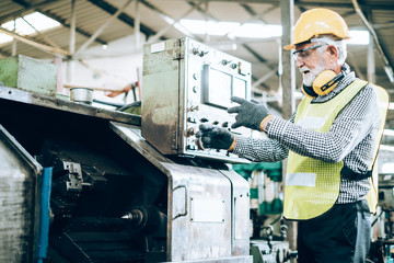 Industrial Engineers in Hard Hats.Work at the Heavy Industry Manufacturing Factory.industrial worker indoors in factory.aged man working in an industrial factory.