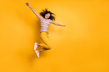 Sticker - Full length body size view of nice attractive ecstatic carefree cheerful cheery wavy-haired girl in striped t-shirt jumping up flying isolated on bright vivid shine vibrant yellow color background