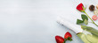 Red rose, strawberries, chocolates and champagne on a white background with a copyspace.
