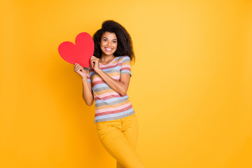 Canvas Print - Portrait of nice attractive cheerful cheery wavy-haired girl in striped t-shirt holding in hands heart human health care clinic center isolated on bright vivid shine vibrant yellow color background