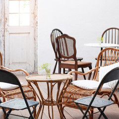 Interior living room vintage conception, rattan table and chair set in dinning room, classic house interior.