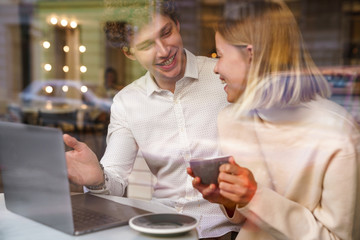 Canvas Print - Happy young colleagues working on laptop computer