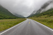 © Tatiana - The road leading a mysterious valley surrounded by clouds of the Norwegian mountains.