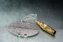 Dog Tag With Water Drops And Empty Practice Ammunition Pods Photographed In The Studio