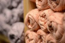 Close Up Knitting Wool. Wooden Store Shelf With An Assortment Color Yarn For Knitting With Needles.