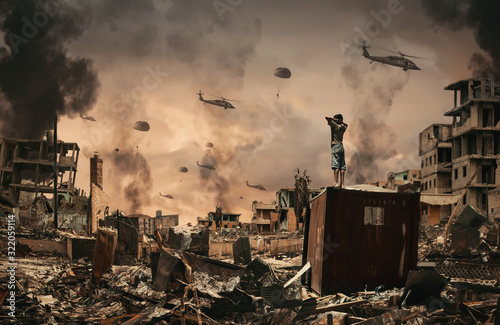 Fotomural Homeless little boy watching Helicopters and soldiers in sky in destroyed and bombarded city between smoke