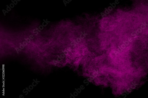 Fotografía Purple color powder explosion cloud on black background