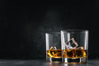 two glasses of alcoholic drink on a dark background