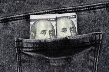 One hundred dollar banknote money in pocket jeans pants background texture. 100 dollar bill close up