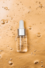 Bottle of hyaluronic acid on background with oxygen bubbles.