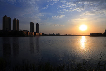 Wall Mural - Waterfront city scenery in the evening, China