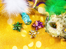 Colorful Mardi Gras Carnival Masks And Green Champagne Bottle On Golden Glitter Background. Festive Holiday Still Life Flat Lay