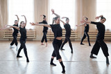 Horizontal shot of contemporary dance team learning new movements in their rehearsal moves
