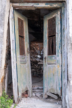Old And Destroyed Double Open Door. Wooden, Peeled, Unlocked Doorway In An Abandoned And Ruined House. Vertical View.