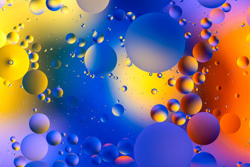 photo, bright oily drops in water with colorful background, close-up