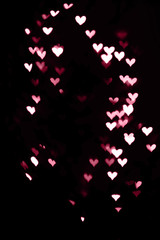 Wall Mural - Bokeh hearts in dark.