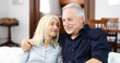 © Minerva Studio - Senior couple relaxing on a sofa and talking together