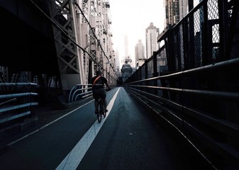 Wall Mural - Man riding a bicycle in a modern city with skyscrapers