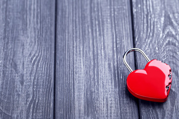 Wall Mural - Valentine heart shaped padlock on black wooden table