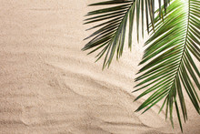 Cross And Palm Tree Leaves On Sand. Palm Sunday Concept. Top View
