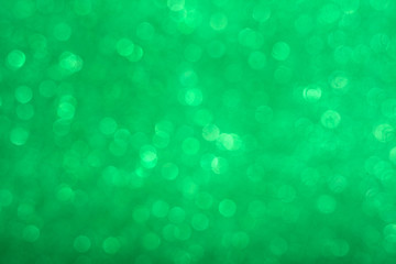 Wall Mural - Abstract shiny circular green bokeh background. Spring